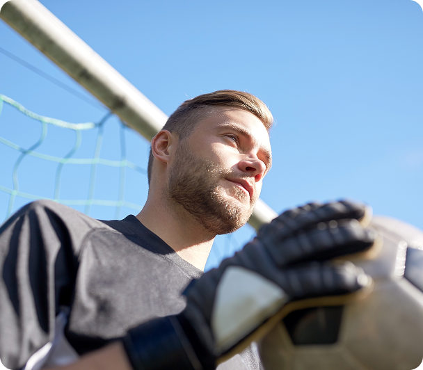 Male soccer goalkeeper wearing gloves outdoors