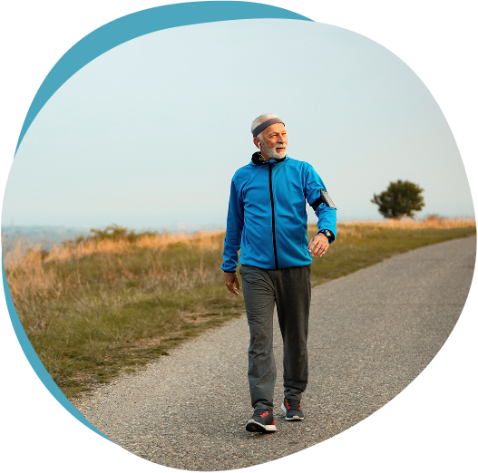 Older man walking outdoors on a path