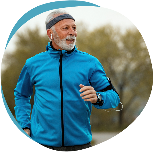 Older man jogging outdoors, wearing an armband and earbuds